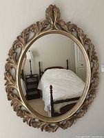 Front view of oval mirror showing entire frame and reflection
