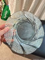 Front view of clear pressed glass bowl showing swirl pattern and scalloped rim