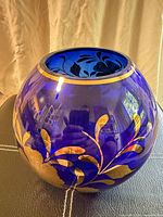 Front view of cobalt blue bowl showing gold floral decoration