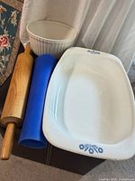 Overview of all items: CorningWare dish, ceramic bowl, wooden rolling pin, blue silicone mat