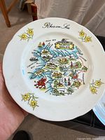 Full view of plate showing map, daffodils, Rhos-on-Sea inscription