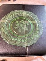 Top view of green etched glass platter showing full pattern and shape