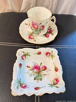 Cup, saucer and square dish with floral design