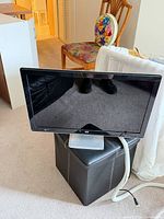 Front view of HP monitor on silver stand with attached cables