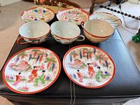 Full set view showing all three teacups and six saucers with painted scenes