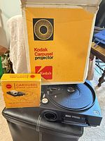 Projector, stack loader box, outer Kodak carton visible together