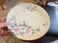 Front view of round porcelain platter showing floral design and background gradient