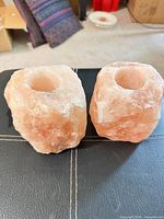 Front view of both salt candle holders showing rough texture and color