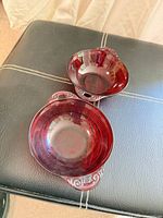 Pair of ruby red pressed glass candy bowls top view