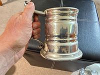 Side view of pewter tankard showing rope handle and ribbed body