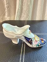 left side profile of porcelain shoe showing hand-painted florals and gilding