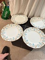 Four Royal Albert Rocaille dinner plates displayed