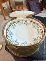 Quilted storage case open showing one Rocaille pattern plate