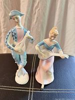 Front view of both Royal Doulton Harlequin figurines showing overall design and size relation