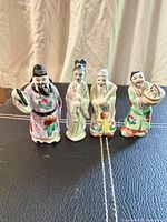 All four porcelain figurines standing side by side