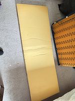 Full view of yellow foam topper on floor