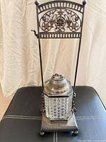 Full view of assembled pickle caster showing stand, handle, glass jar, lid