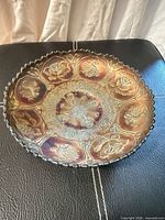 Interior view of iridescent blue carnival glass bowl showing Dragon and Lotus panels and scalloped rim