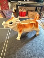 Left side view of cow creamer showing coloration and form