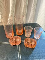 All six pink pressed glass pieces grouped