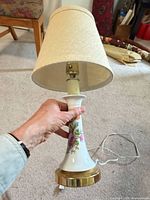 Full lamp with shade, cord, brass base visible