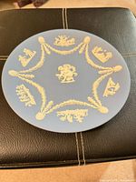 Front view showing blue plate with white relief designs