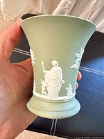 Side view of sage green Wedgwood Jasperware vase showing bas-relief figure