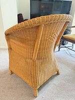 Rear view of wicker rattan armchair showing weave pattern and condition