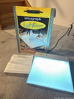 Light box illuminated alongside original box and instructions