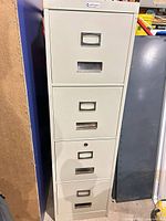 Front view showing four drawers and lock