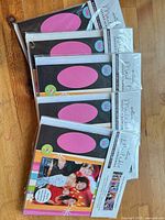Five sealed Hallmark scrapbook kits fanned out on table
