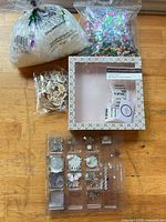 Assorted embellishments including beads, sequins, wooden cut-outs, Martha Stewart box and clear compartment tray