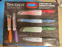 Front of unopened Tomodachi 6-piece knife set packaging showing all knives and guards