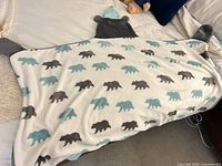 Wearable blanket laid flat showing full bear print design, hood, mittens and foot pockets