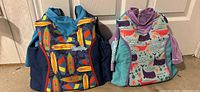 Front view showing both vests’ patterns and logos