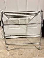 Front view of chrome three-tier towel rack