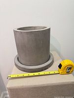 planter with saucer next to tape measure showing ~8 in diameter