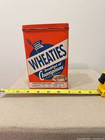 Front view showing Wheaties logo and tape measure for scale