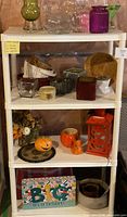 Full view of shelving unit with assorted decor items