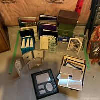 Entire lot showing albums at back, frames in middle, boxes to right and left