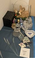 Entire lot showing straw rabbits, glass figurines cluster, ceramic dish, glass stems and black box