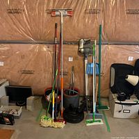 Full view of grouped cleaning items inside green tape border