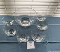 Top view of large bowl centered with six small bowls around