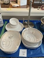 Front view showing both covered casseroles, ramekins nested in pie plate behind