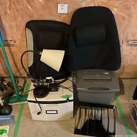 All items grouped together showing shredder, lamp, cushions, box, sorter
