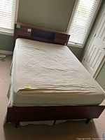 Full bed showing headboard, mattress, frame