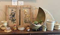 entire lot on mantel showing plaques, planter, ceramics, figurines