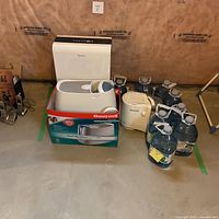 Group shot of Danby unit, Honeywell boxed humidifier, tabletop humidifier and water jugs