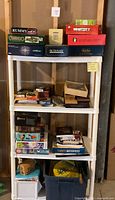 Full view of white plastic shelving with games and puzzles