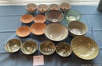 Full lot of assorted bowls laid out on table